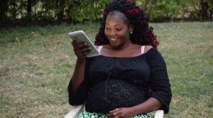 Former Rongo University Student Sharon Otieno Using a Smartphone