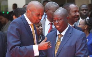 Public service CS Hon. Moses Kuria chats with Deputy President Hon. Rigathi Gachagua during a past state event