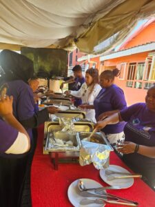 Agnes Kagure helped serve food during a recent meeting.