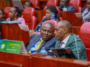 Kimani Ichung'wah consulting with Nixon Korir during a past event