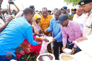 PS Raymond Omollo distributing relief food during a past exercise 