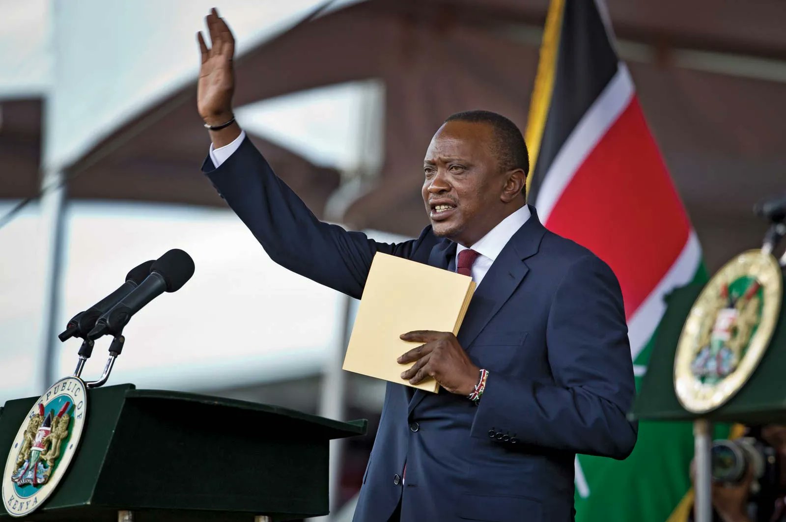 Former President Uhuru Kenyatta waves attendees of a past meeting.